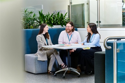 A diverse team sharing ideas during a relaxed brainstorming session.