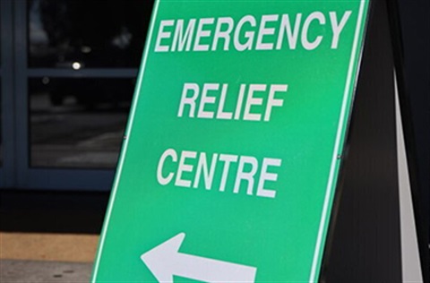 The text Emergency Relief Centre on a green portable sign.