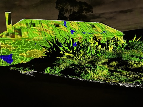 Ziebells Museum with green & yellow light projection celebrating Australian's athletes