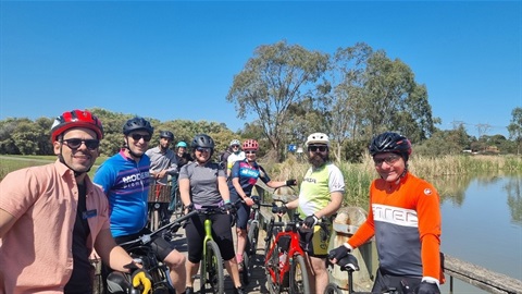 Group of cyclists enjoying a sunny day out on the trail.
