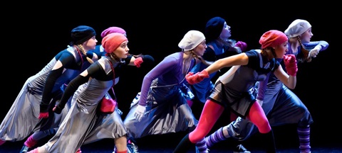 Young people are performing on a stage in a free dance workshop