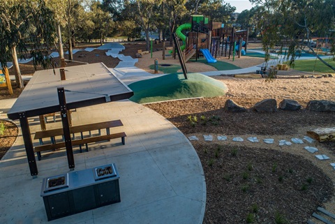 Aerial view of playground including a shelter and barbeque