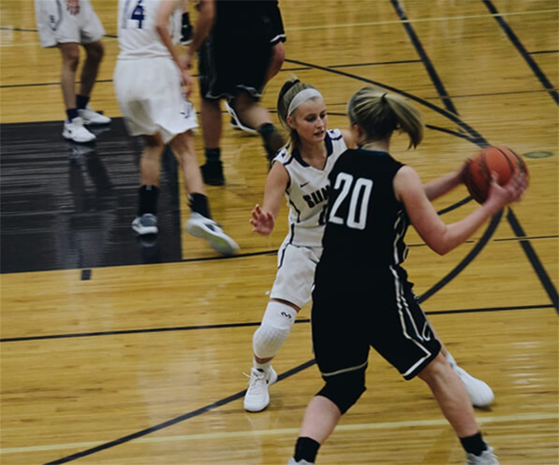 Two teenage basketball players compete for the ball at Mill Park Stadium
