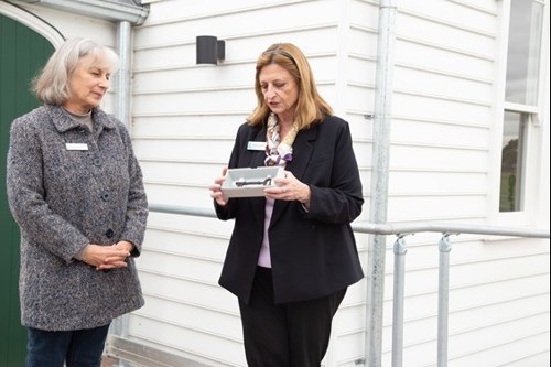 Colleen Lazenby and Mary Ann Rosenthal with original church key in front of Wollert Church