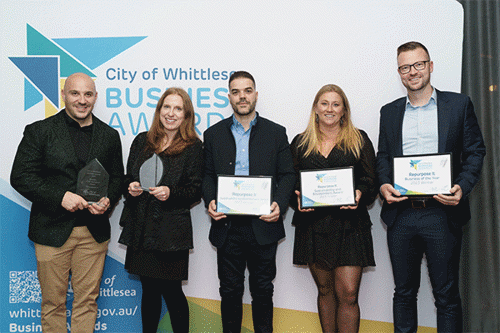 Five staff from Reurpose It hold their award trophies and certificates.