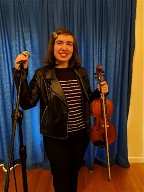 Musical talent, ready to inspire; a performer with a violin and microphone.