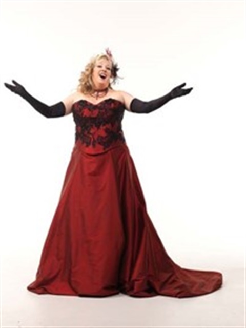 A moment of pure artistry.  A woman in a magnificent burgundy gown, ready to perform.